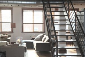 A nicely decorated living space with air ducts visible